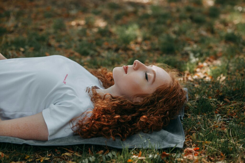 a woman being deeply relaxed, taking good care of her health and nervous system through deep belly breathing techniques